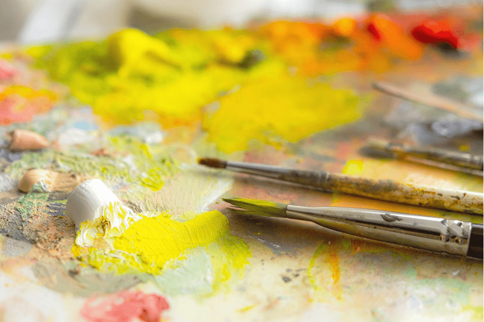 paint brushes and oil pants on an artist's pallette